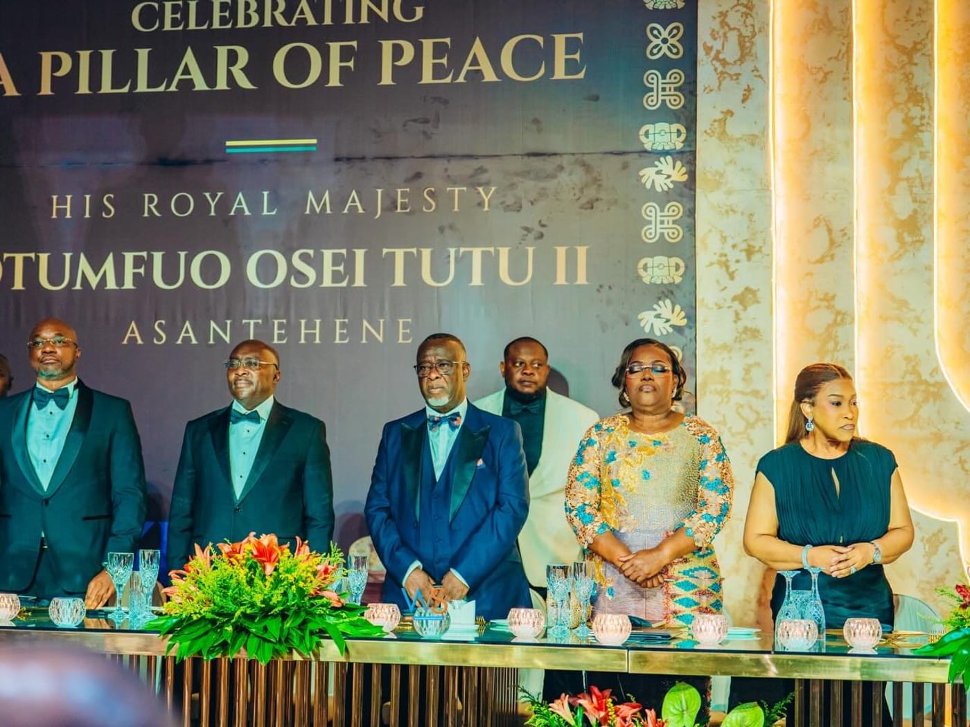 Dignitaries stand beneath a banner reading A Pillar of Peace at the 27th coronation anniversary of Otumfuo Osei Tutu II in Kumasi.